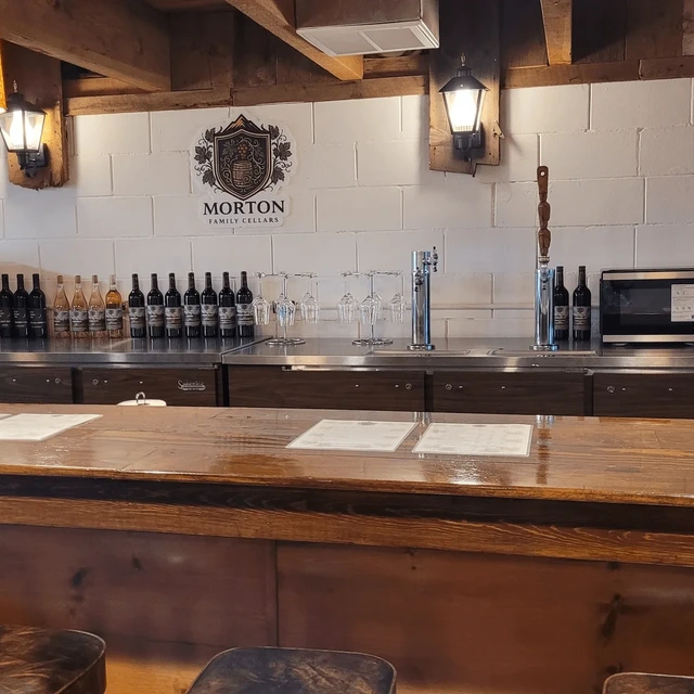 The Morton Family Cellars tasting bar, with the family crest above a row of bottles