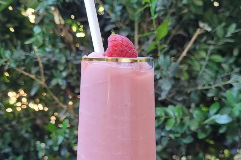 A pink frozen wine slushie with a raspberry on top, served at Morton Family Cellars